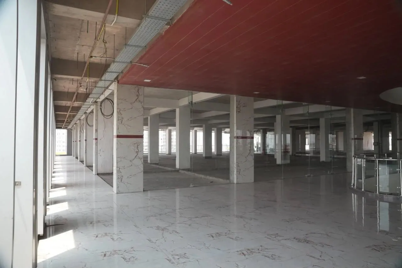 An open bare-shell floor with polished stone flooring, ready for fit-out