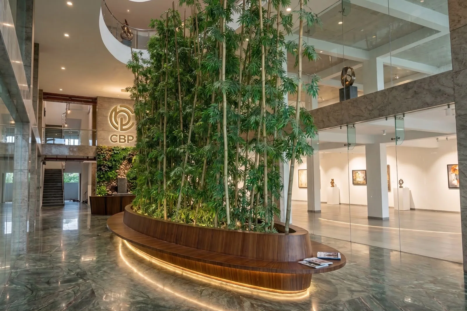 The atrium lobby at Chaitanya Business Park, with bamboo planting and the CBP monogram